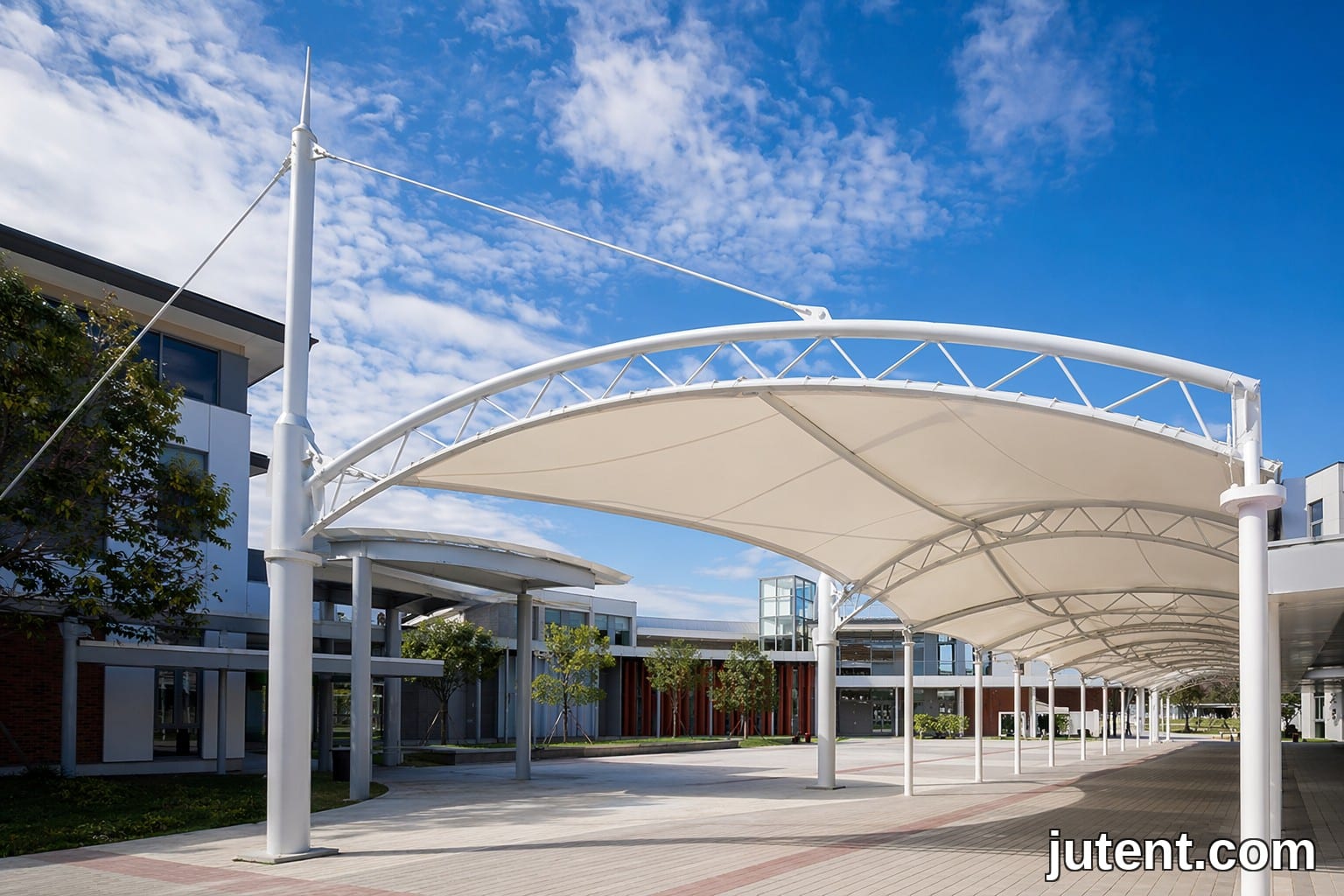 Engineered tensile membrane canopy covering a school walkway in Australia, designed for AS/NZS 1170.2 wind loads and UPF 50+ UV protection