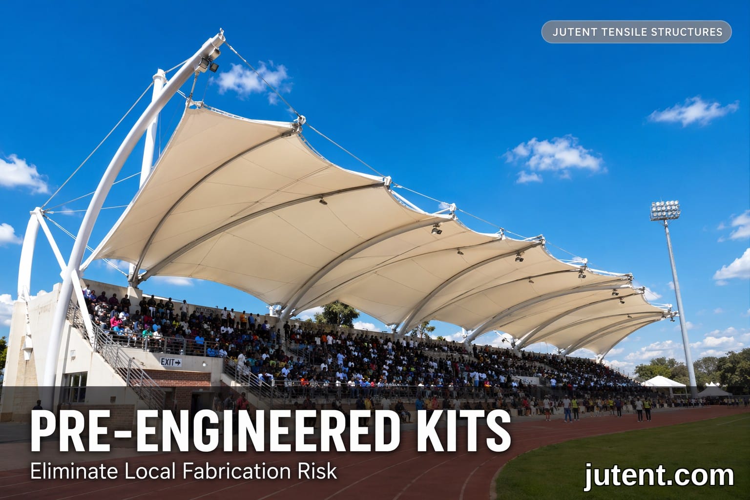 Large-span white PVDF tensile membrane canopy over a stadium grandstand in Africa, supported by steel masts and cables
