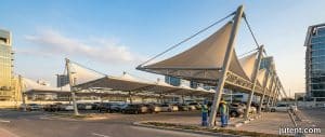 Jutent tensile carport shading vehicles in Middle East parking facility with 45°C heat protection