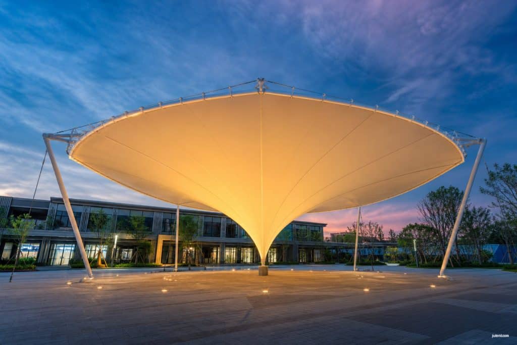 Inverted umbrella fabric tensile structure shading a modern commercial plaza with high-tension membrane roofing by Jutent