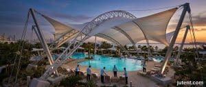 Durable tensile membrane pool shade structure in Dubai resisting 45°C heat and chlorine corrosion for Gulf aquatic facilities