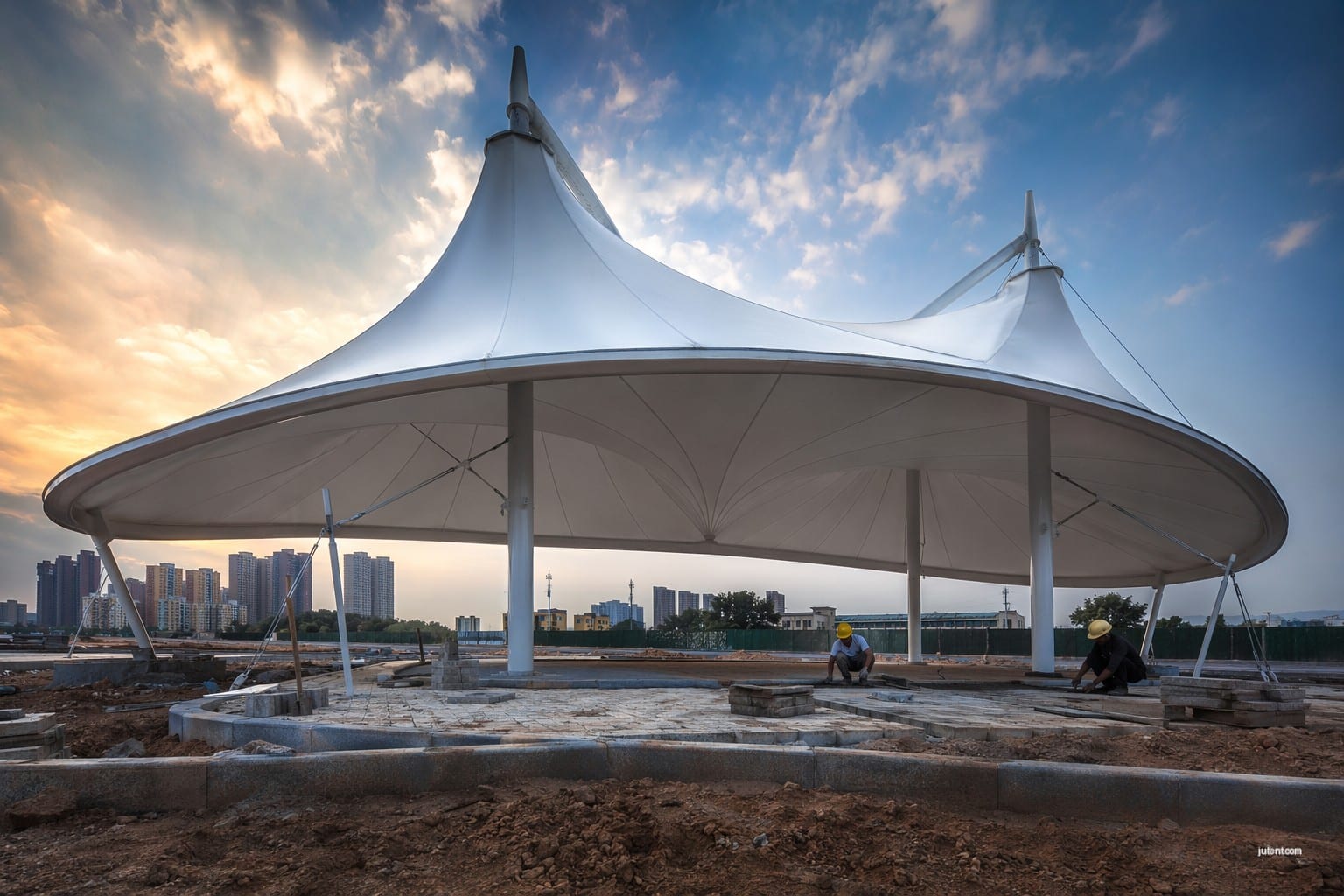 Tensile membrane canopy drainage design with slope and curvature for water runoff on commercial structure