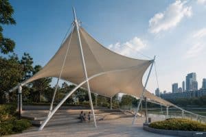 Large-scale tensile membrane shade structure at Nanning Min'ge Lake urban park, featuring modern canopy design for pedestrian weather protection
