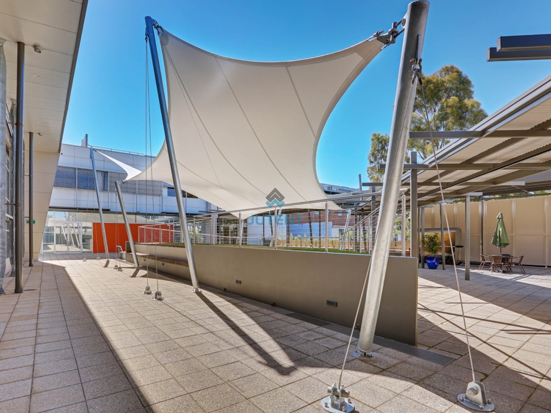 Commercial Plaza Tensile Membrane Canopy Tensile membrane canopy covering open shopping mall plaza providing shade for public gathering space