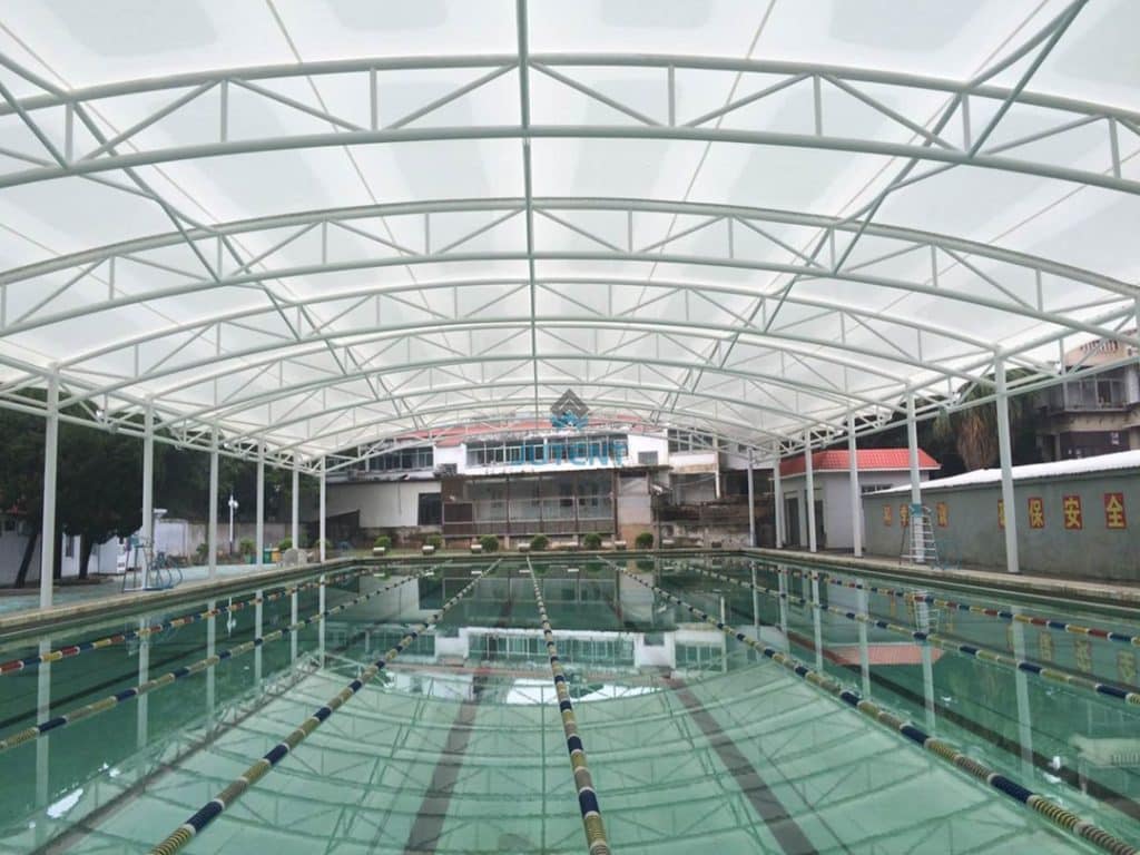 Waterproof tensile fabric shade canopy for outdoor swimming pool patio area