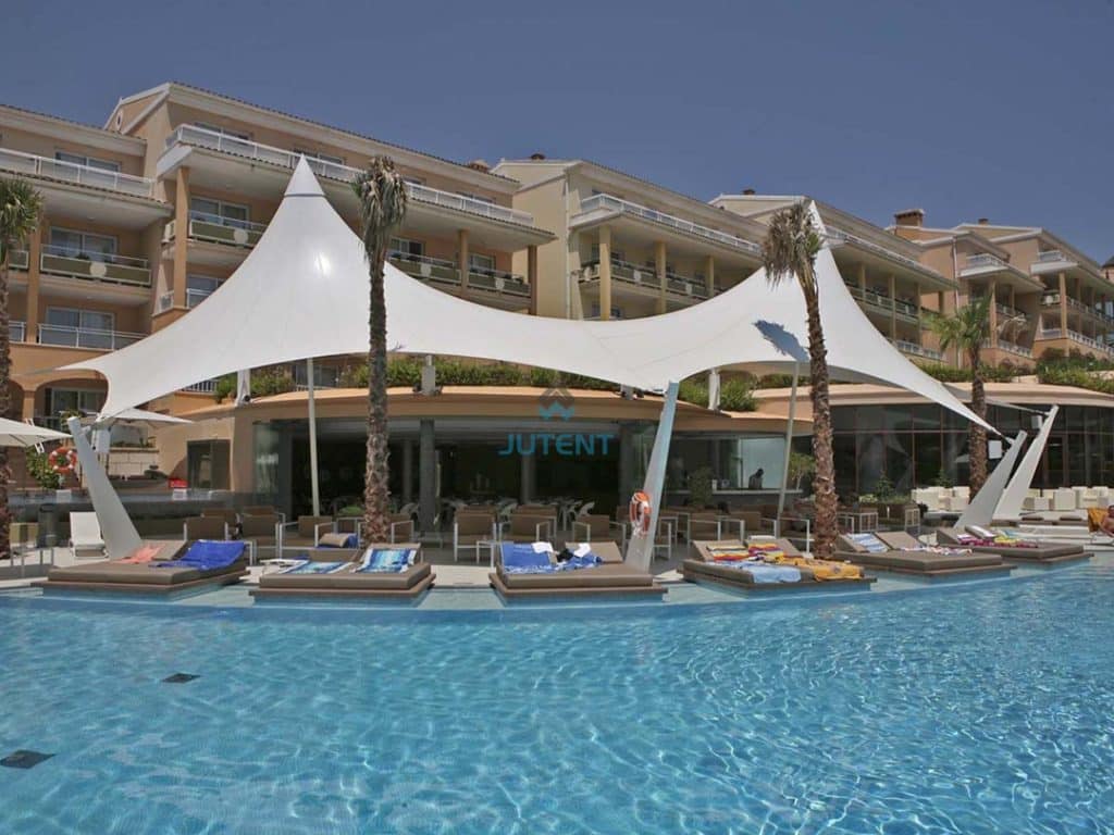 Swimming pool bar shaded by tensile membrane canopy structure