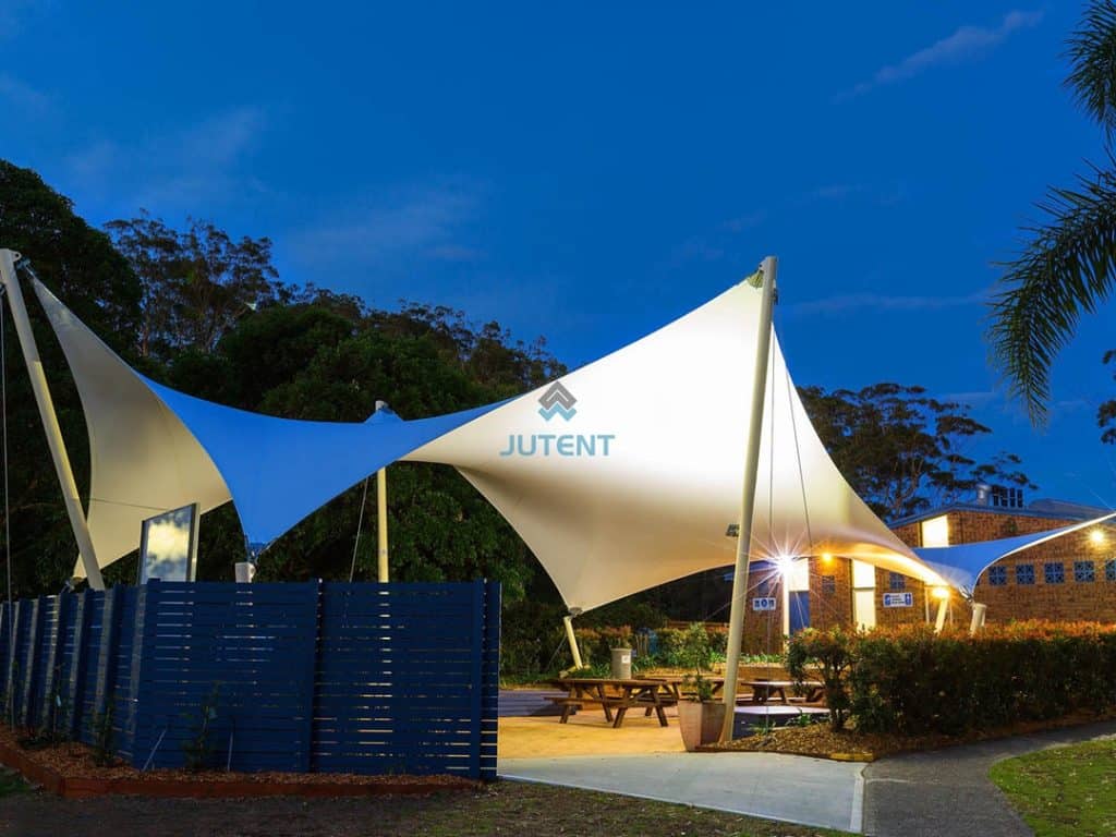 tensile fabric canopy installed over outdoor dining areas
