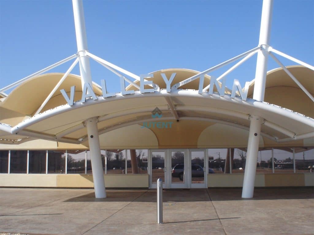 Tensile membrane canopy installed at shopping mall entrance providing sheltered access