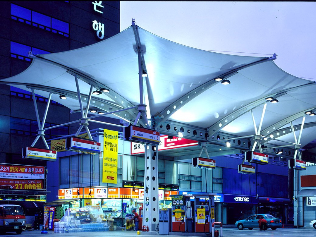 gas-station-canopy-night-lighting.jpg Illuminated inverted umbrella tensile membrane canopy at a commercial gas station during nighttime.