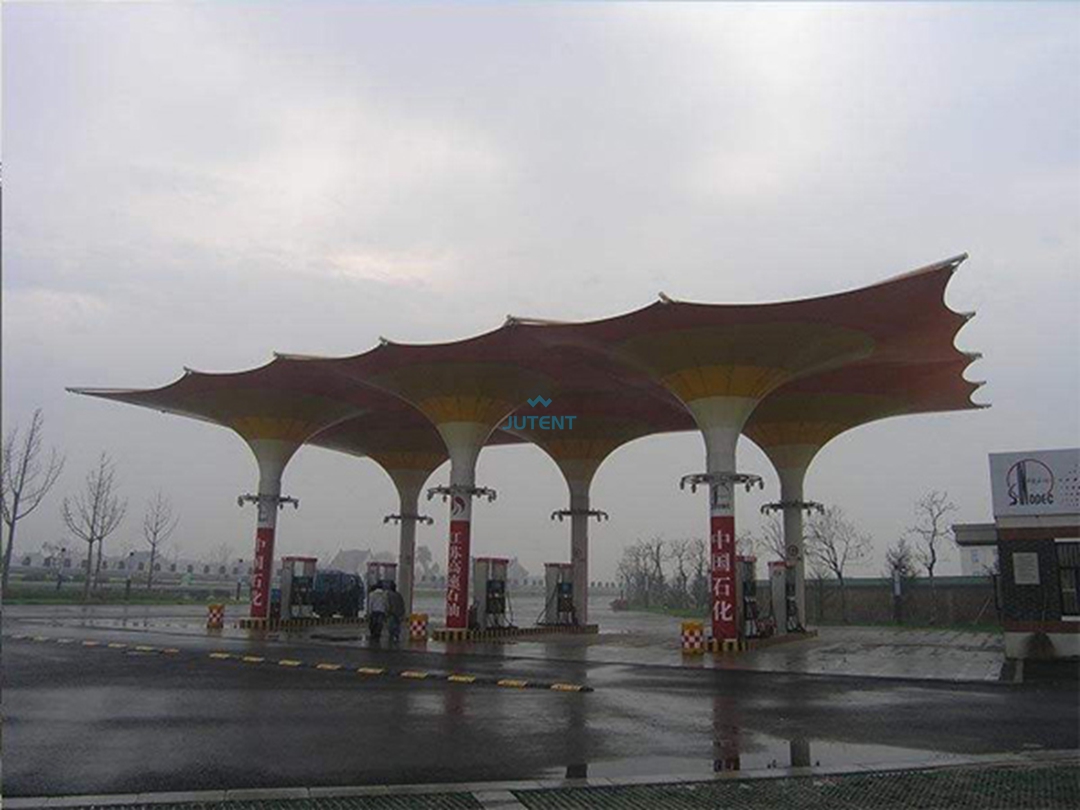 pvdf-membrane-gas-station-canopy.jpg PVDF tensile membrane surface used in a commercial fuel station canopy for UV and weather protection.