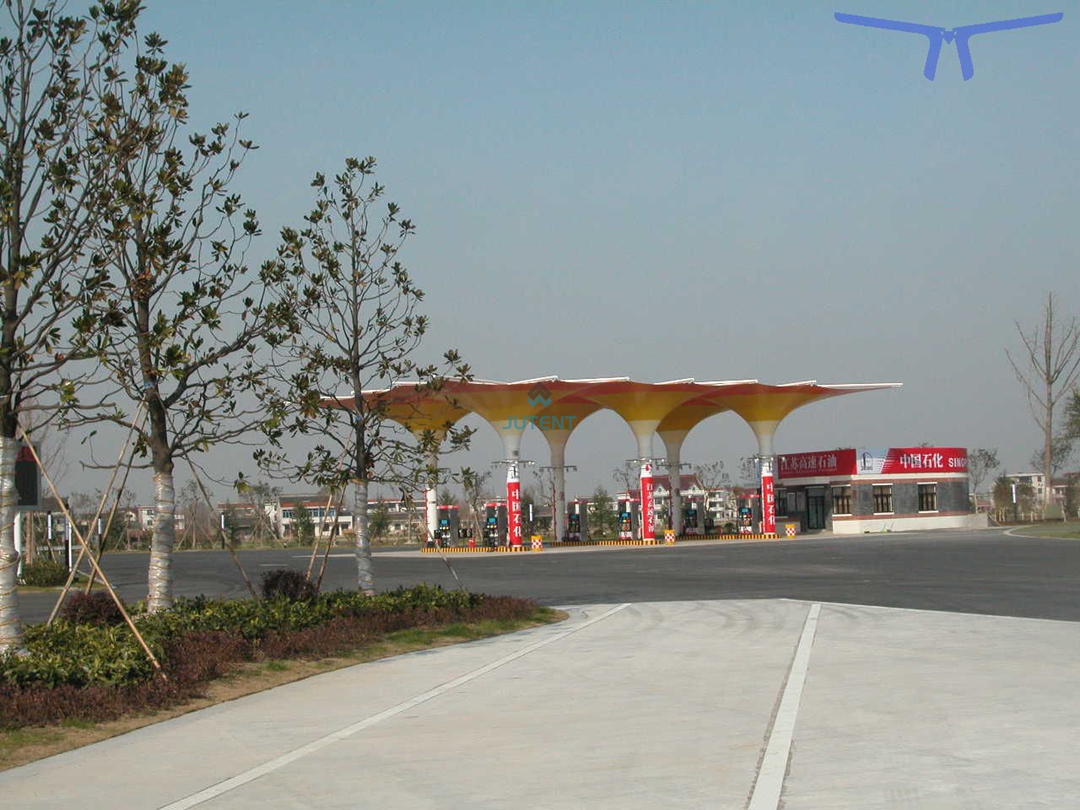 multi-bay-gas-station-canopy.jpg Multi-bay inverted umbrella tensile membrane canopy covering several fueling pumps at a petrol station.
