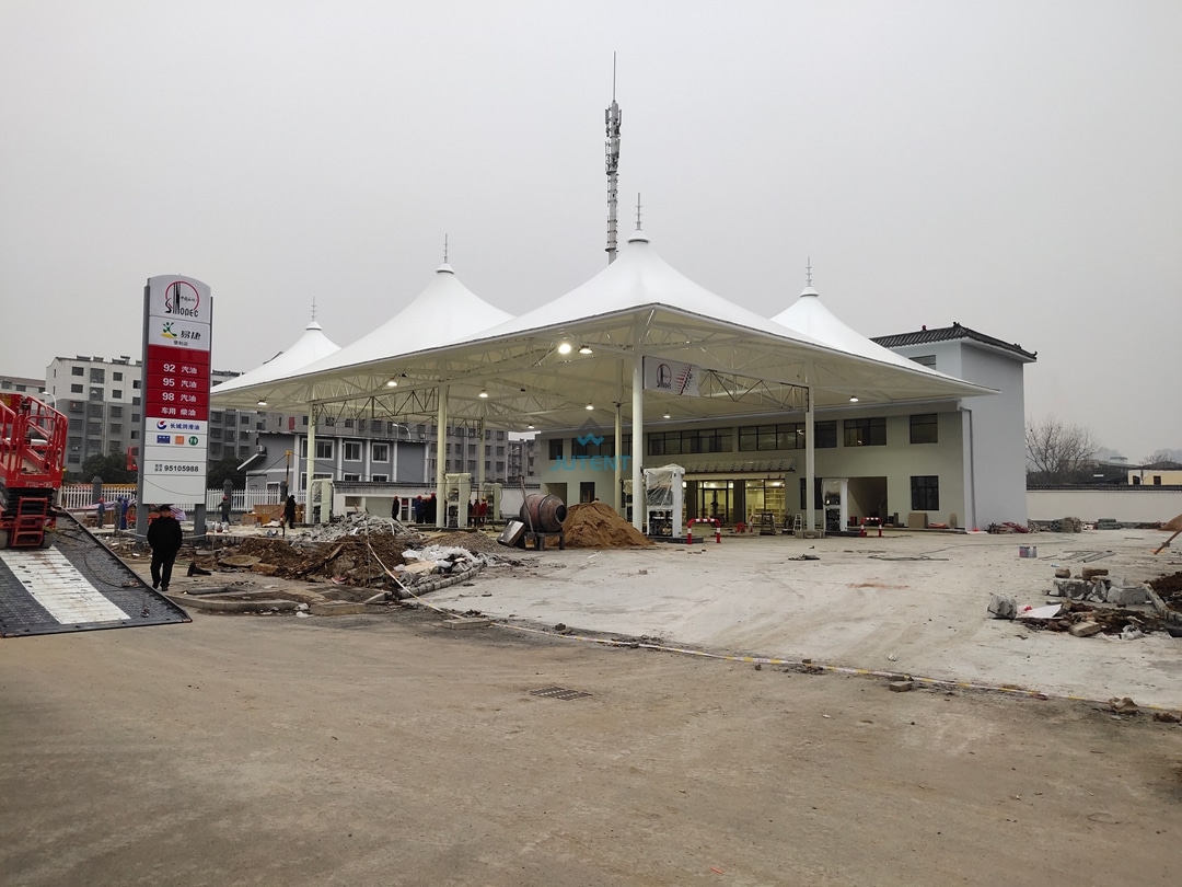 Gas station tensile canopy g05 Large span commercial gas station canopy covering multiple fueling bays with tensile membrane structure design.