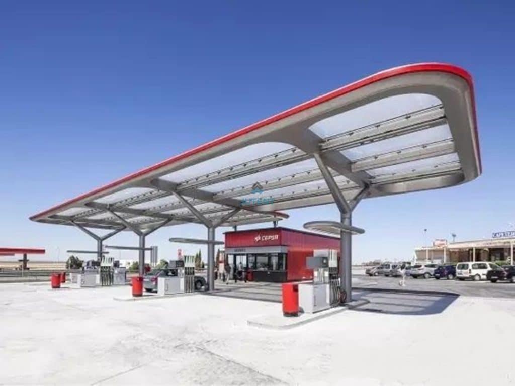 Contemporary fuel station canopy with lightweight roofing system providing full coverage for service area.