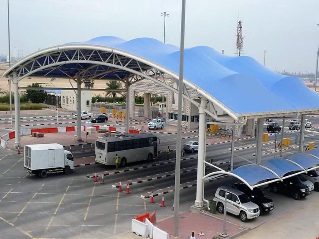 PVDF-coated architectural membrane used in a highway checkpoint canopy for UV and weather protection.