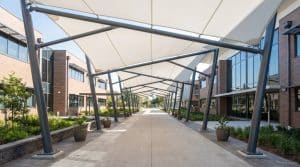 Tensile membrane school walkway canopy between campus buildings